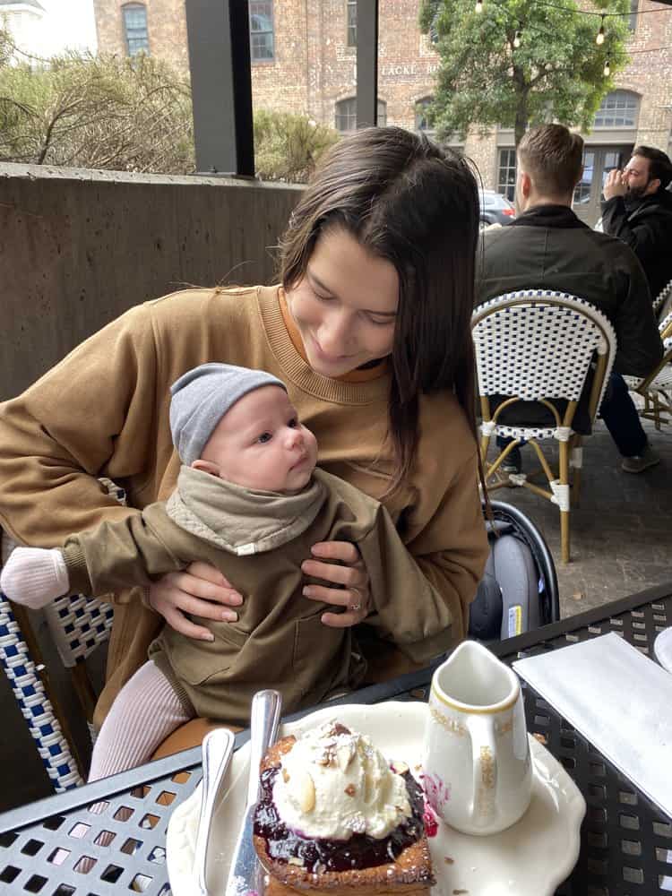 Mother holding baby on her lap at restaurant