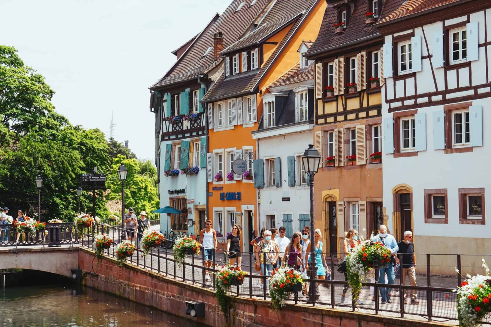 people walking along gorgeous french town river