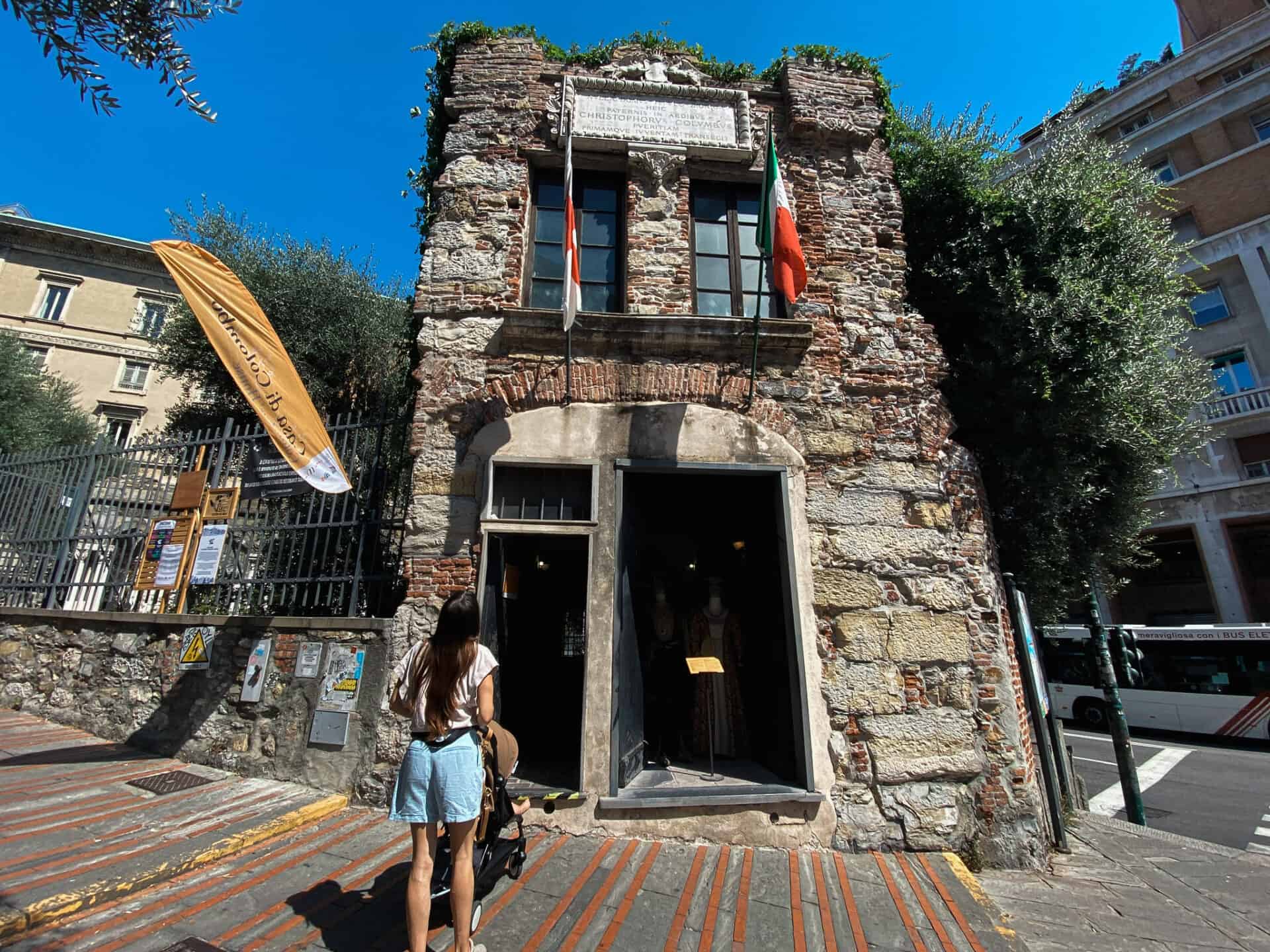 Woman and her baby outside of the House of Christopher Columbus in Genoa Italy