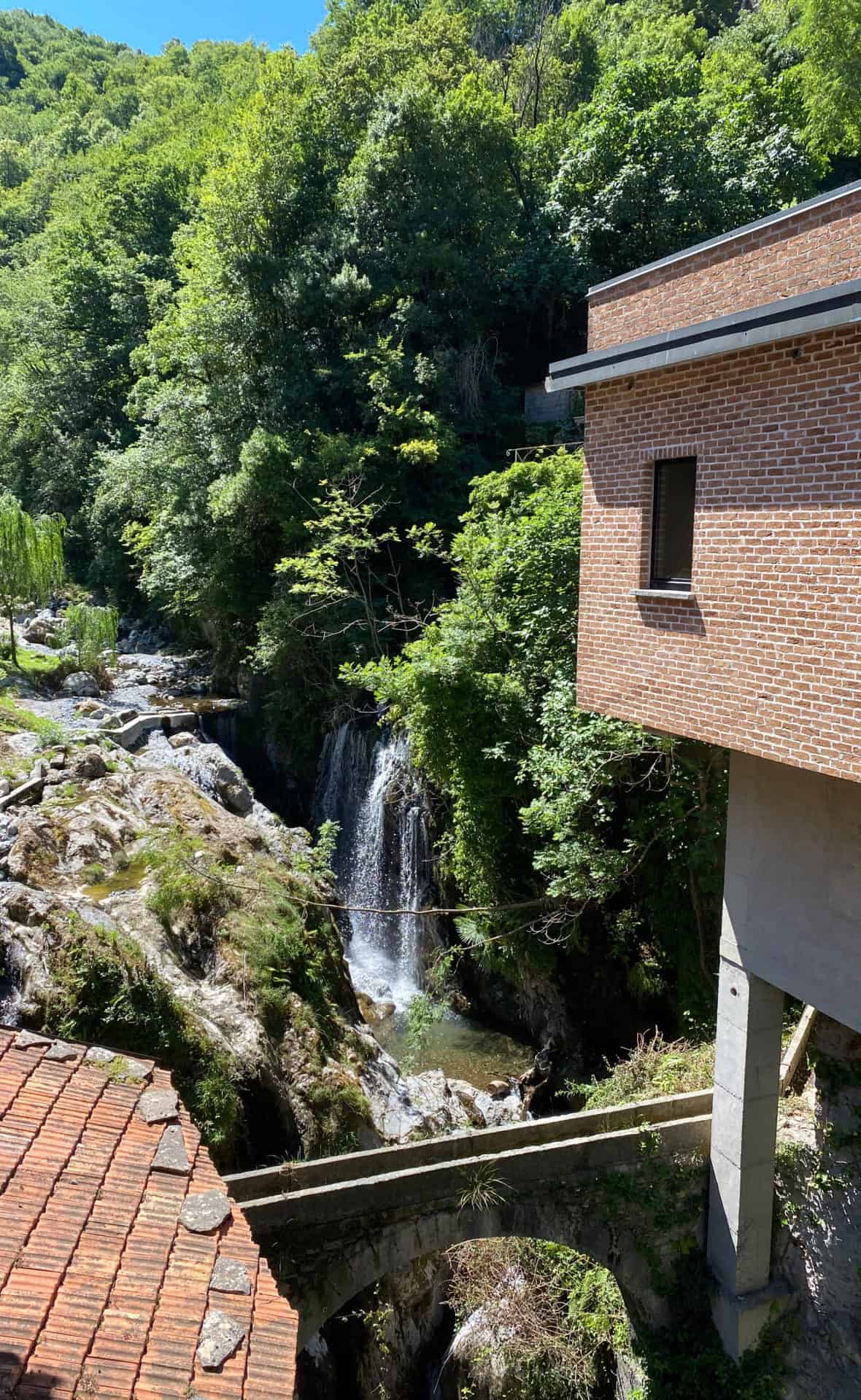 magical waterfall at Lake Como with beautiful green vines