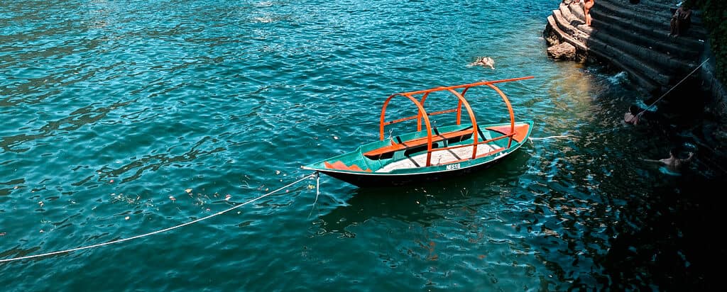 Italian gondola in deep blue lake