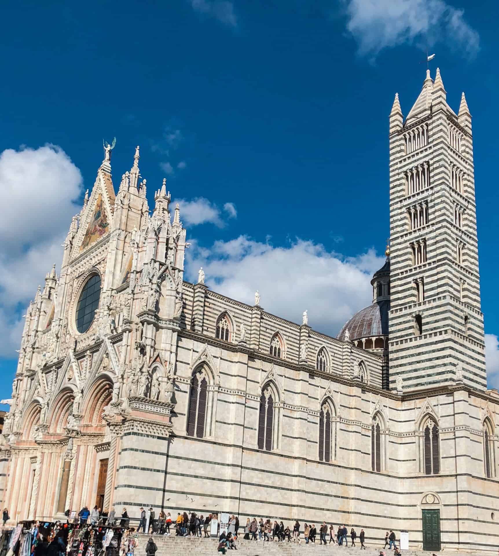 exterior of white cathedral Santa Maria Assunta in Siena