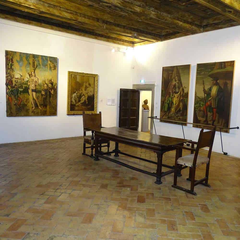 dining room table with paintings on the walls in Raffaelo's childhood home