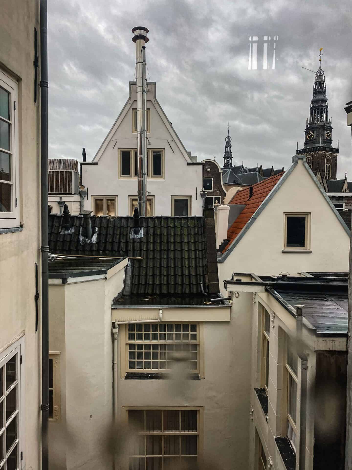 View of Amsterdam through a window on a cloudy day