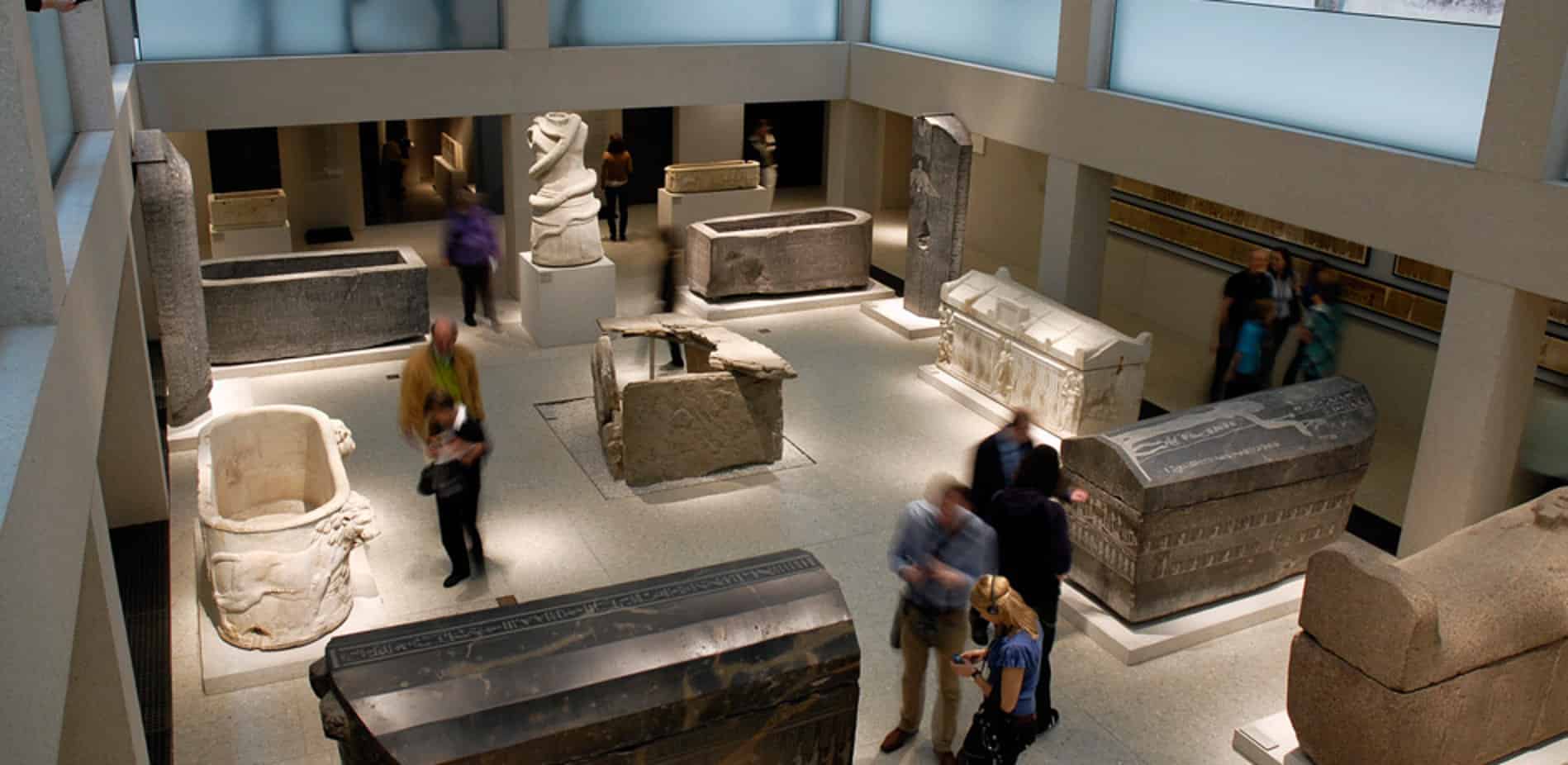 visitors walking in an egyptian museum exhibit