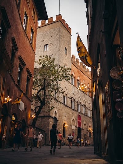 castle in the middle of a street in siena italy