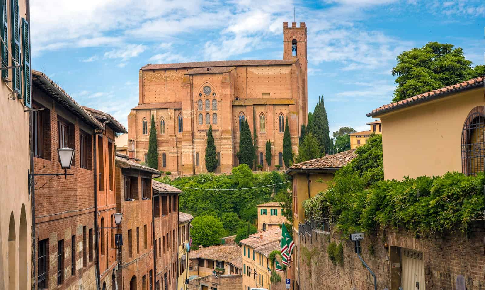 landscape photography of siena with san domenico church on the hill