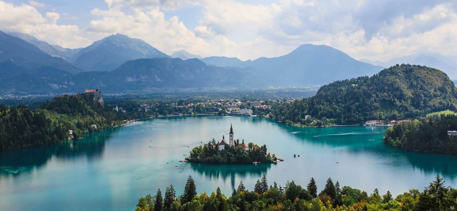 high-angle photography of white church on island in middle of Lake Bled