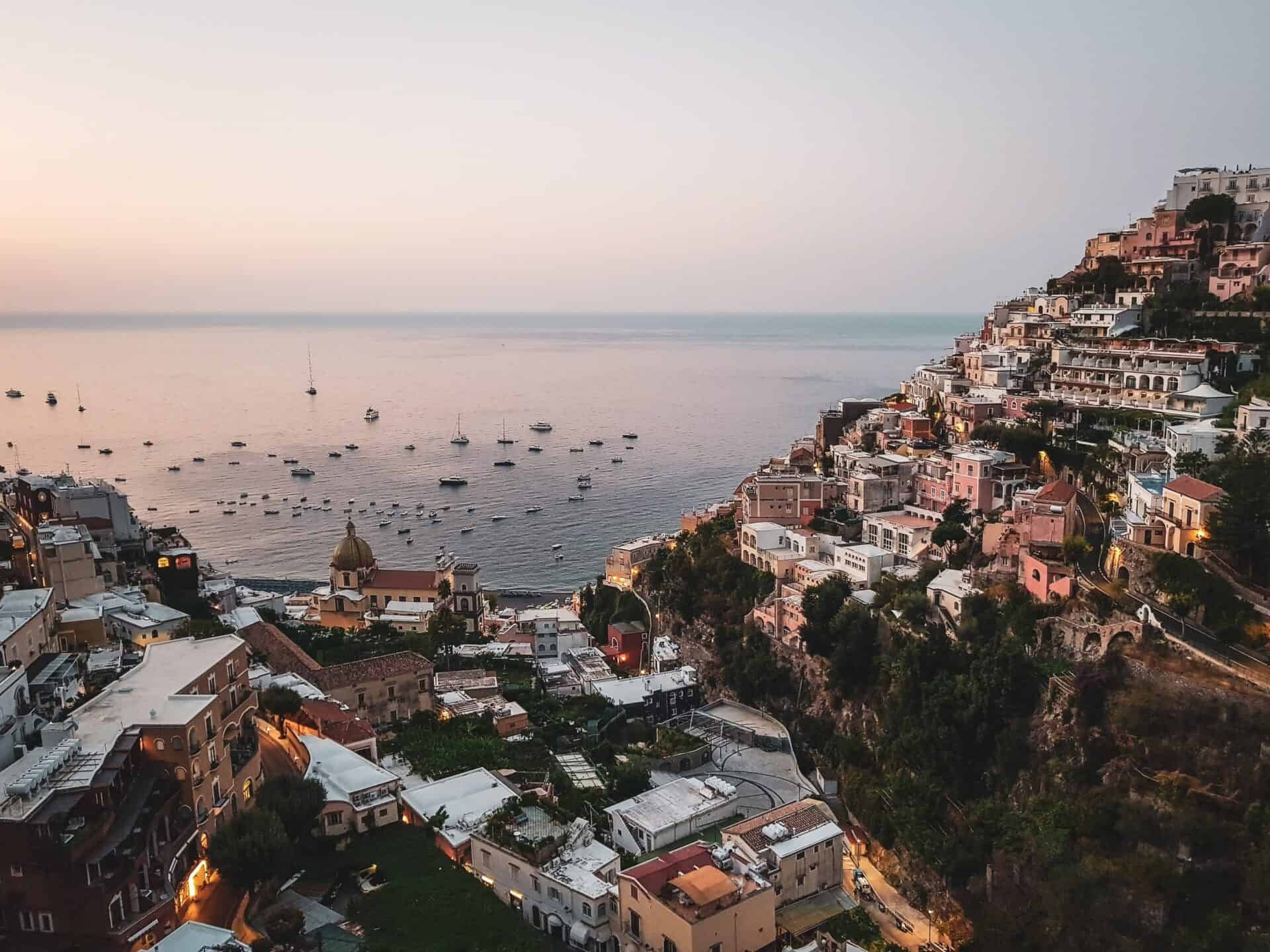 Buildings on cliff in the Amalfi Coast overlooking the Mediterranean sea at dusk