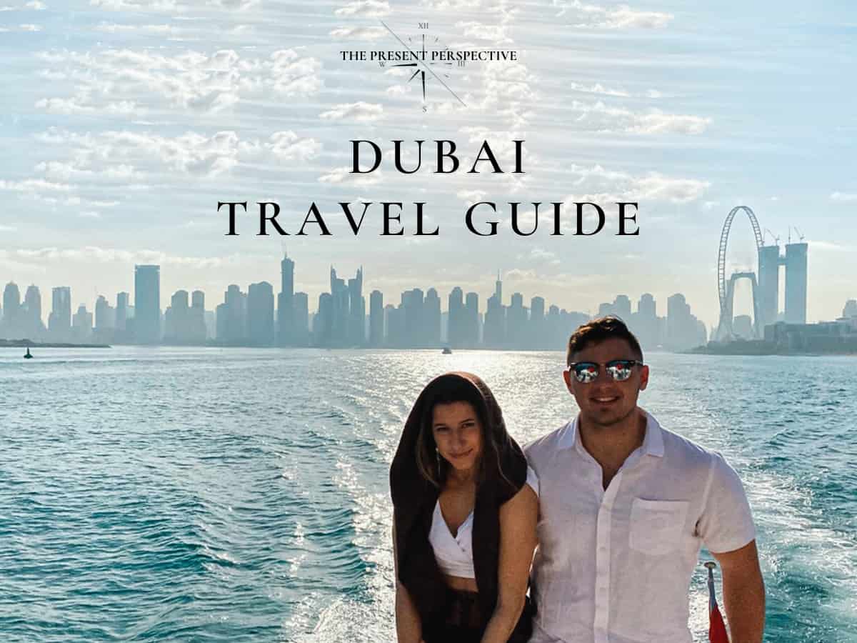 Man and woman on yacht in Dubai marina with city skyline in the background