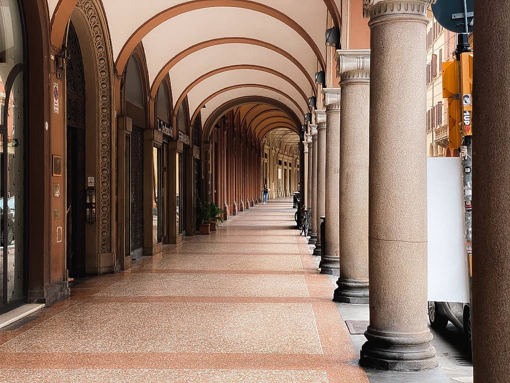 long hallway of archways in bologna italy