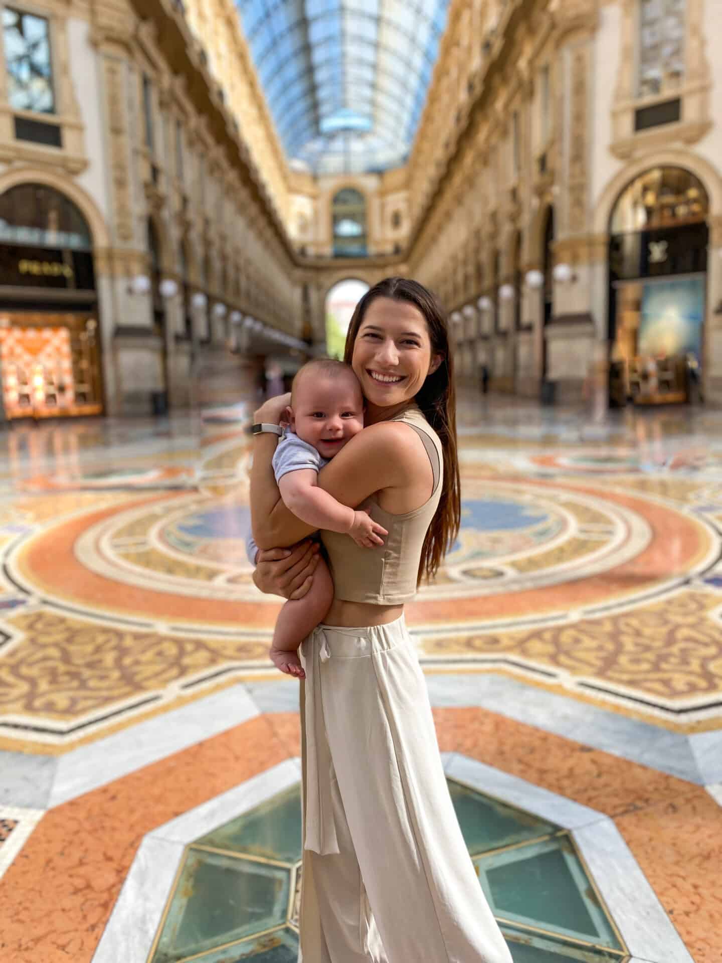 mother and smiling 6 month old baby at Galleria early in the morning in milan