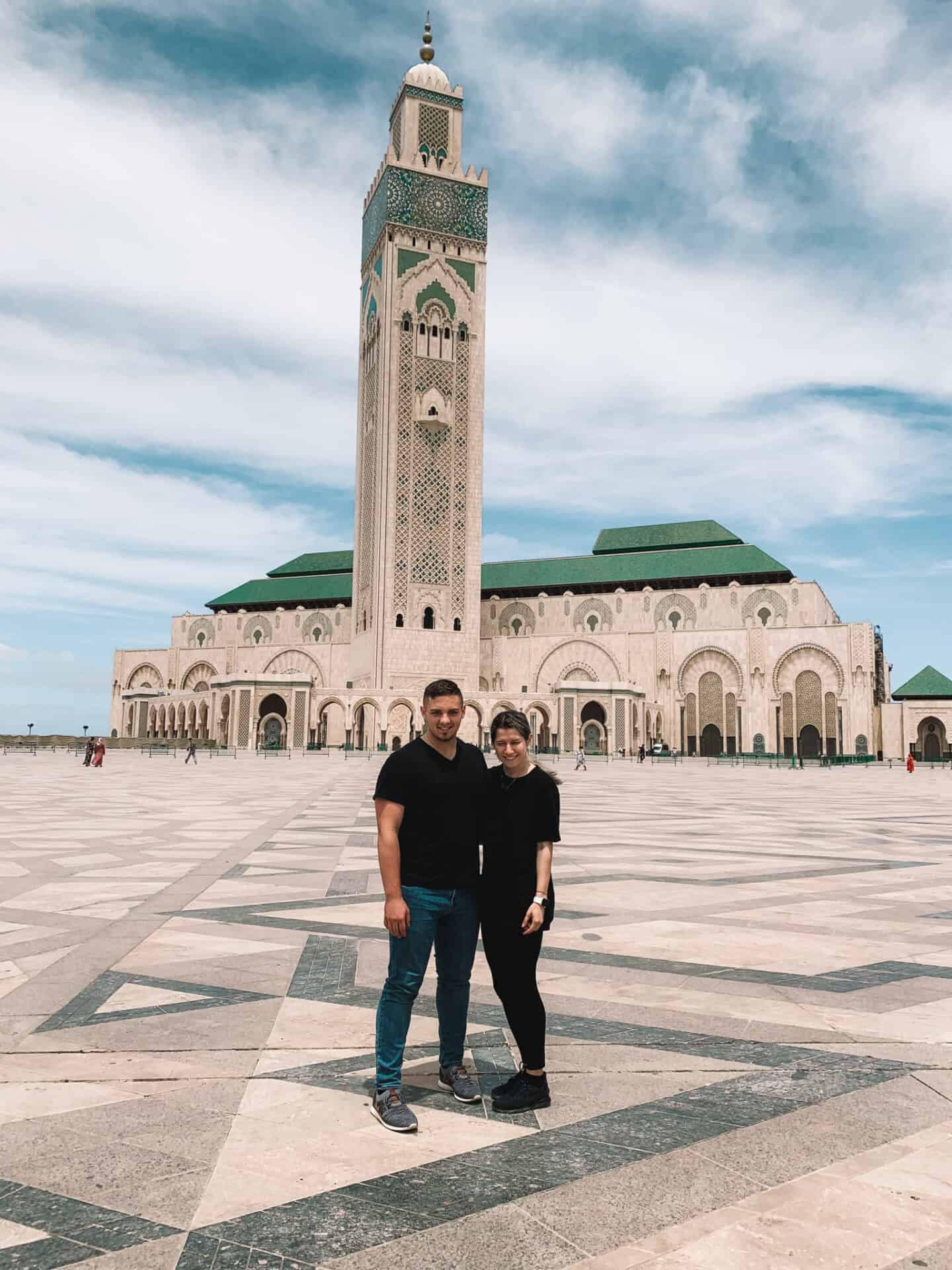 Couple dressed in black in front mosque in Casa Blanca