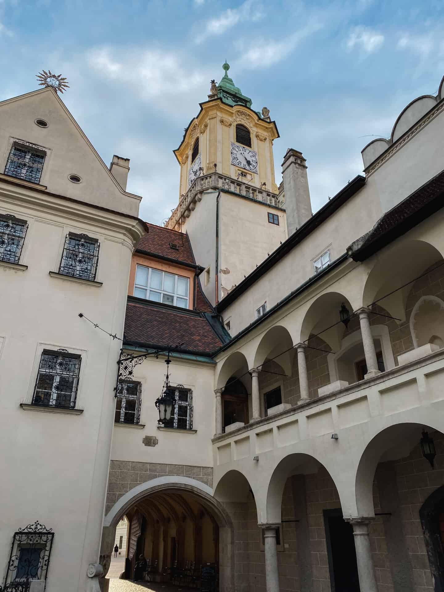 Yellow clocktower on a cloudy day in Bratislava