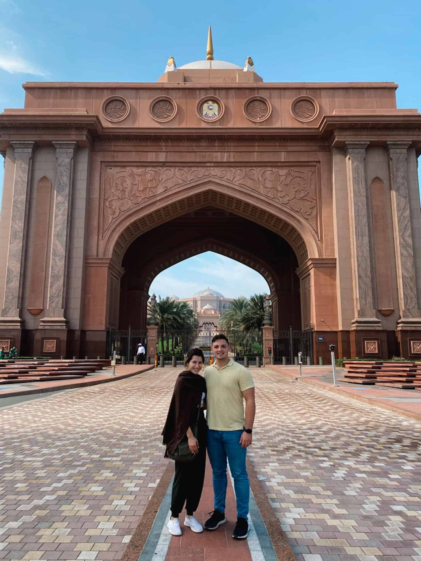 Couple standing in front of the Royal Emirate Palace in Abu Dhabi