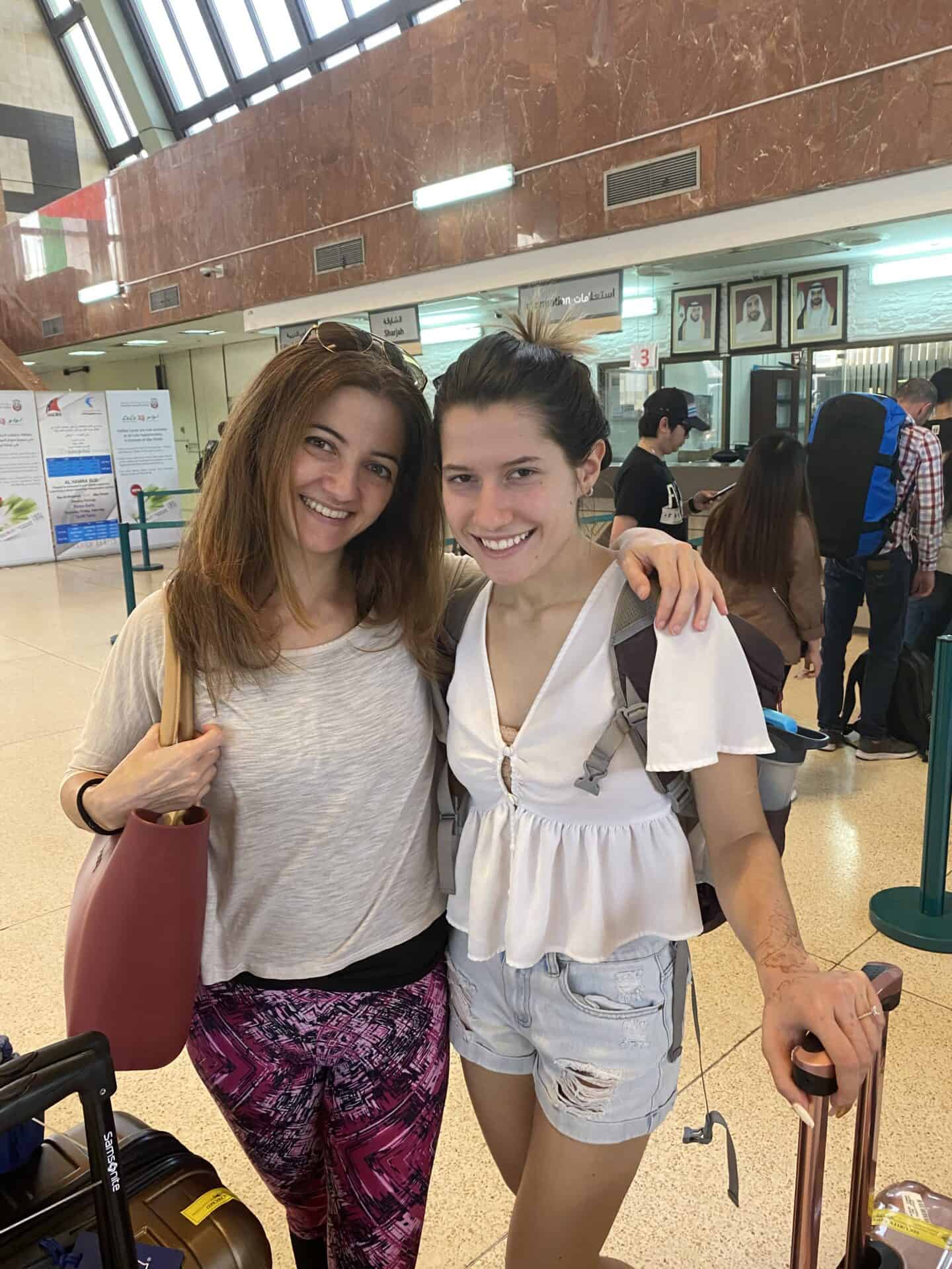 italian female Cousins standing in Abu Dhabi Bus station