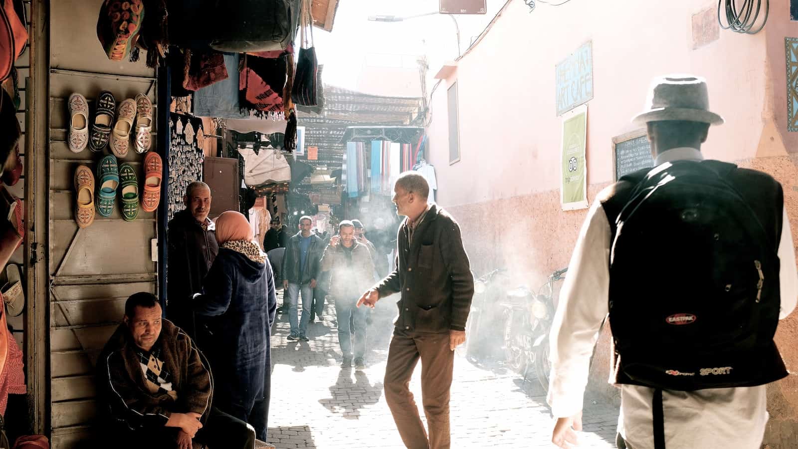 people in smoky souk alley in morocco