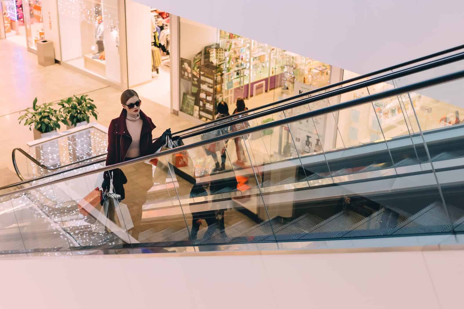 woman shopper riding escalator in luxury dubai mall
