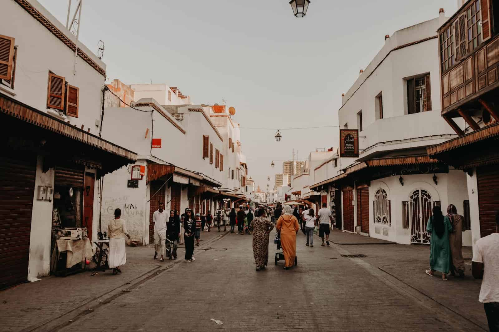 Food vendors and people on small street in Medina in Rabat