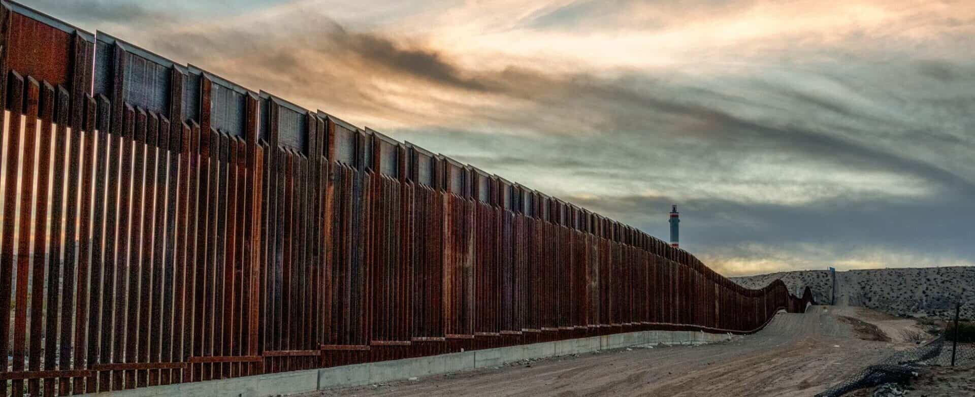 the mexico US border in the dessert at dusk