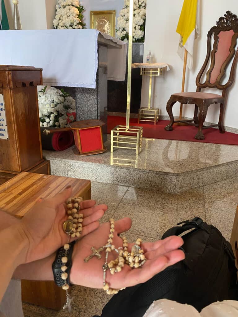 two rosaries in the palm of a catholic couple's hands