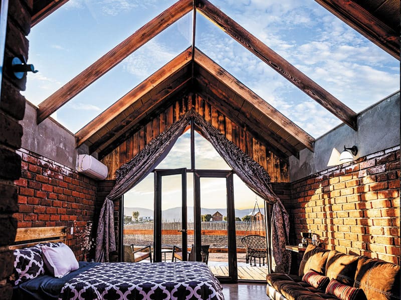 cabin with glass ceiling and bed