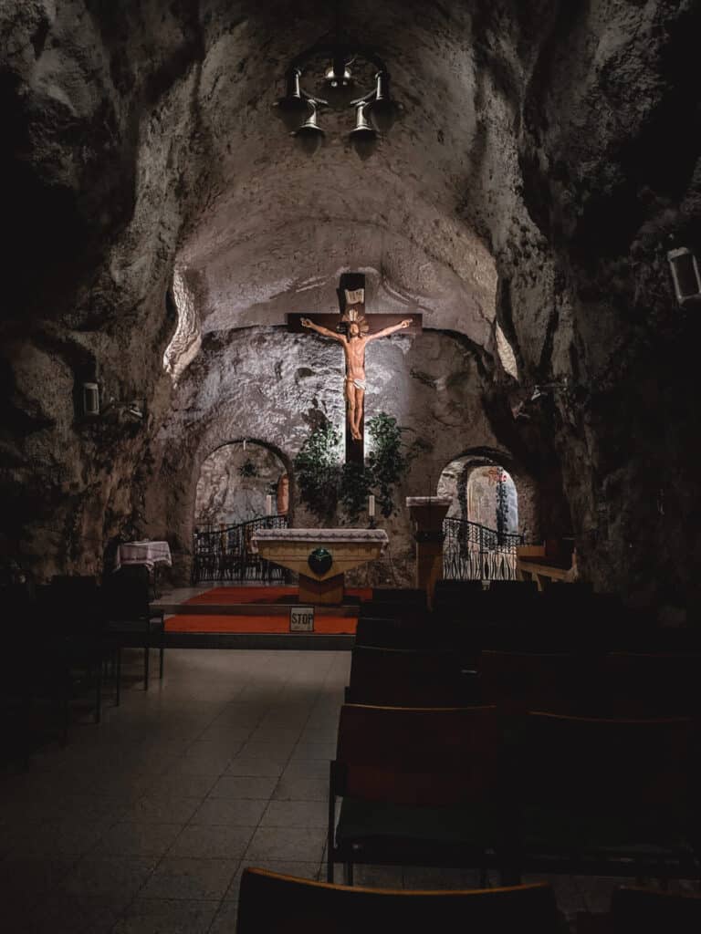 crucifix and church altar in a dark cave