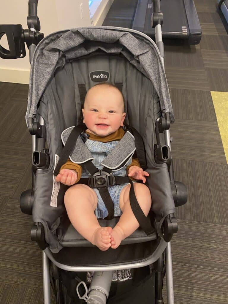 happy baby sitting in a stroller