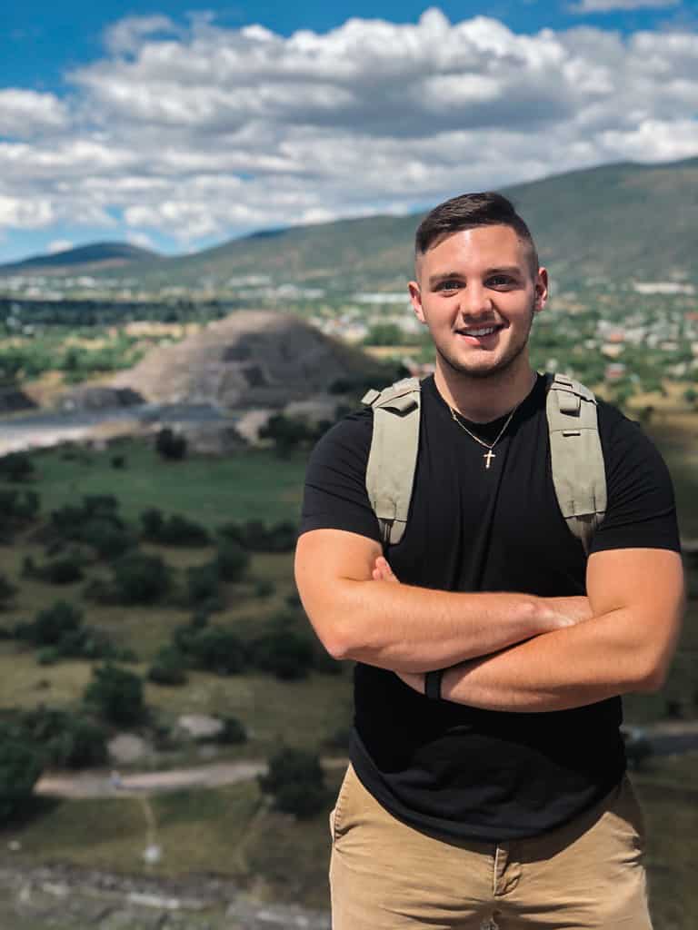 male model in black t-shirt at pyramids in mexico