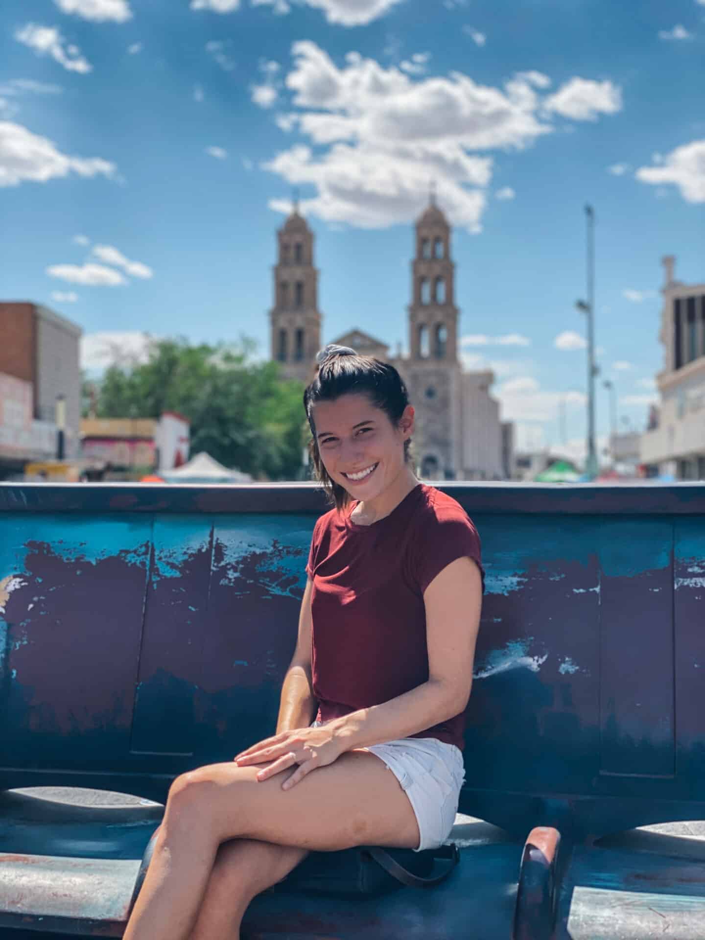 American woman sitting on a bench in the center of Ciudad Juarez