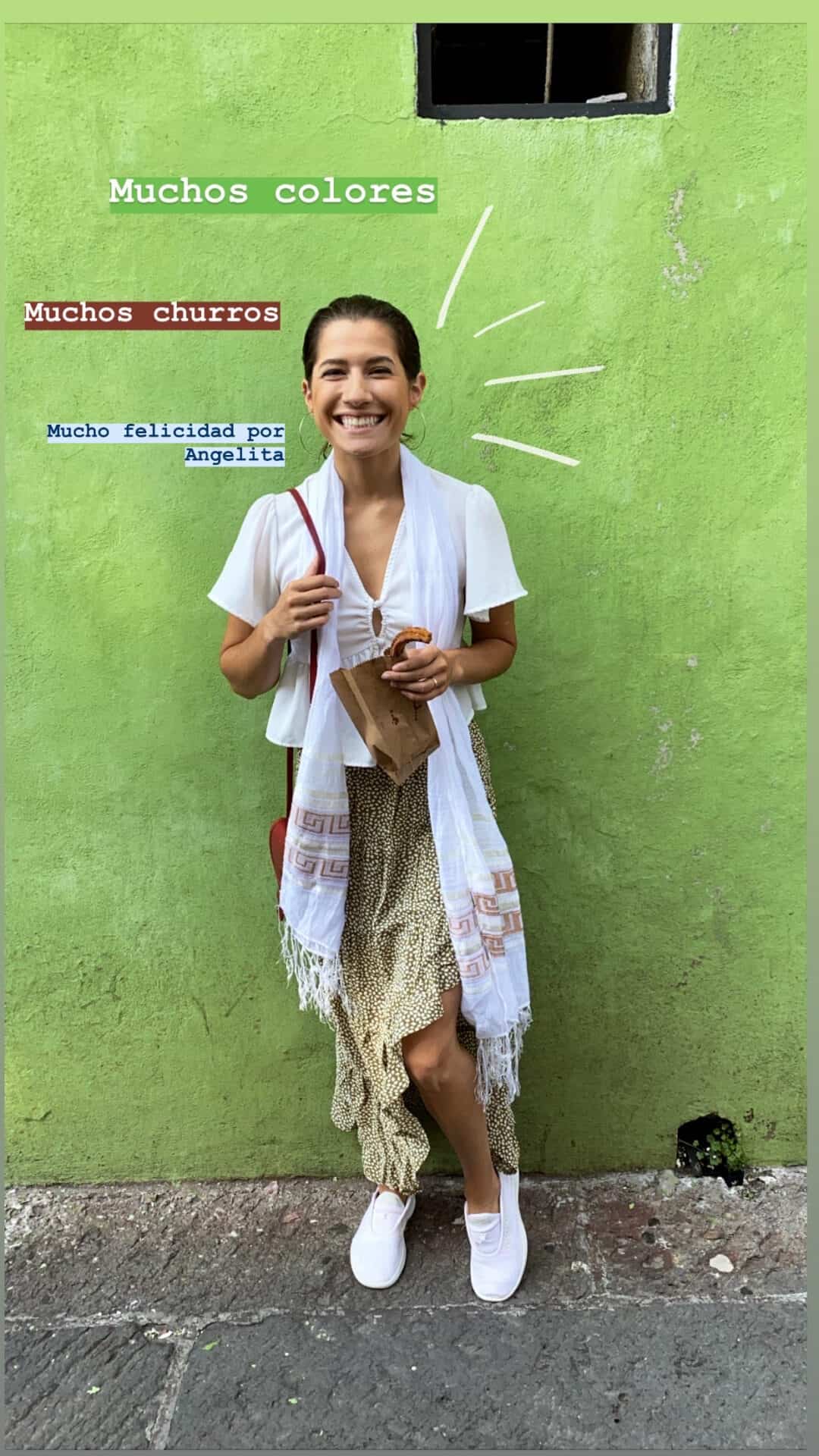 woman on a colorful street in mexico smiling