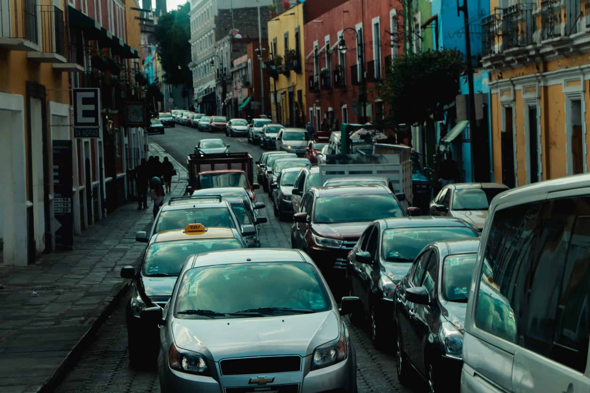 Lines of traffic on cobblestone street in Puebla, Mexico