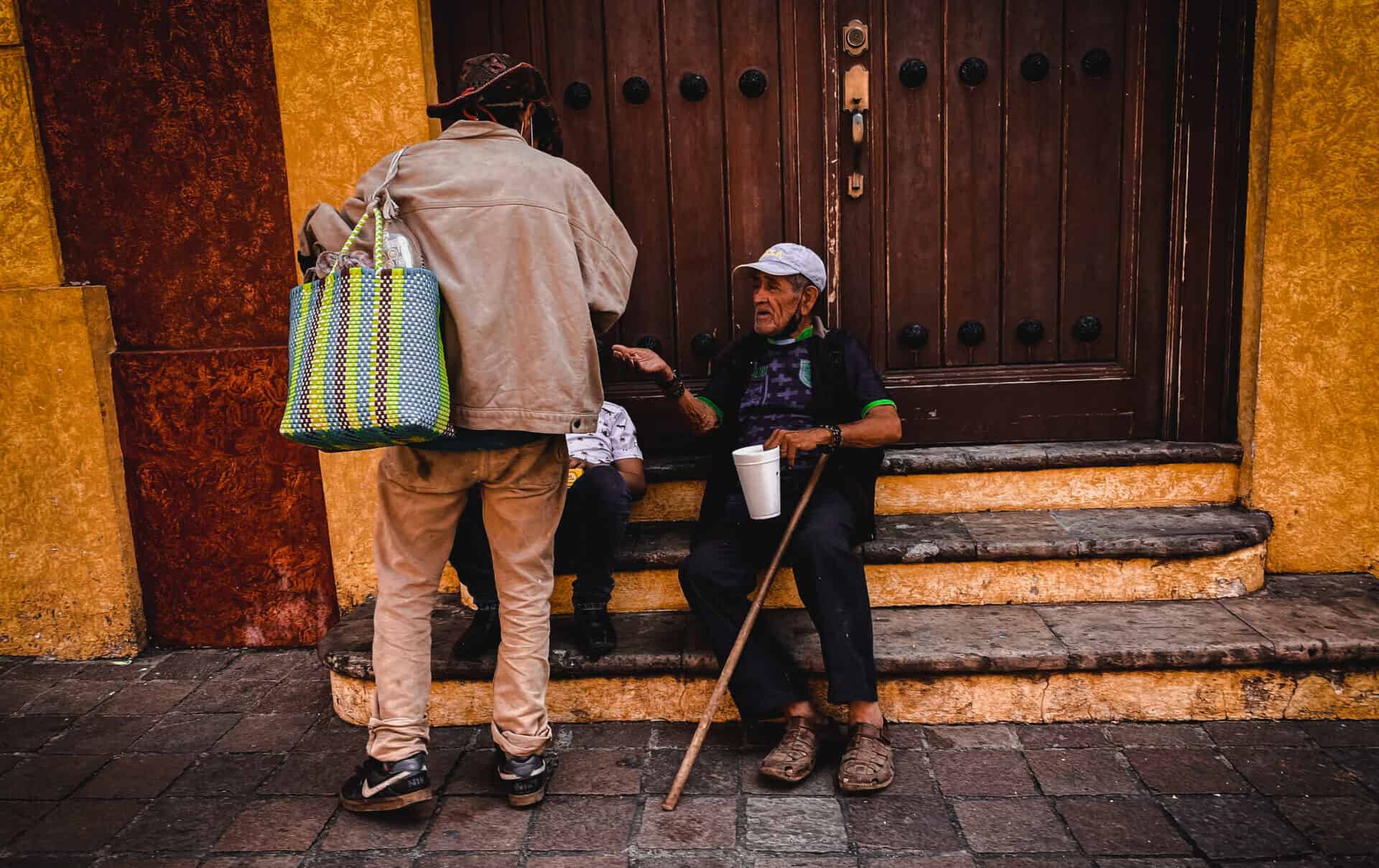 two elderly men sitting on steps in mexico