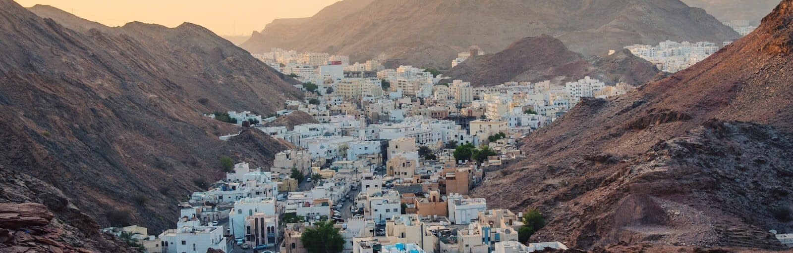 aerial view of mountain city of muscat during dusk