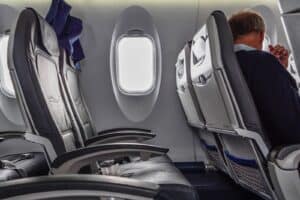 row of airplane seats and airplane window