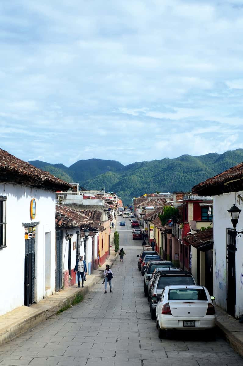 cars parked besides mexican mountain street during daytime