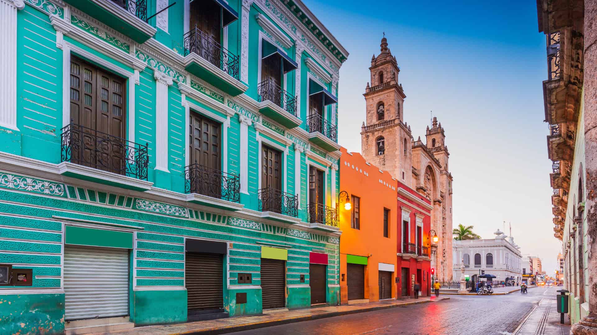 street in mexico with colorful blue building and church