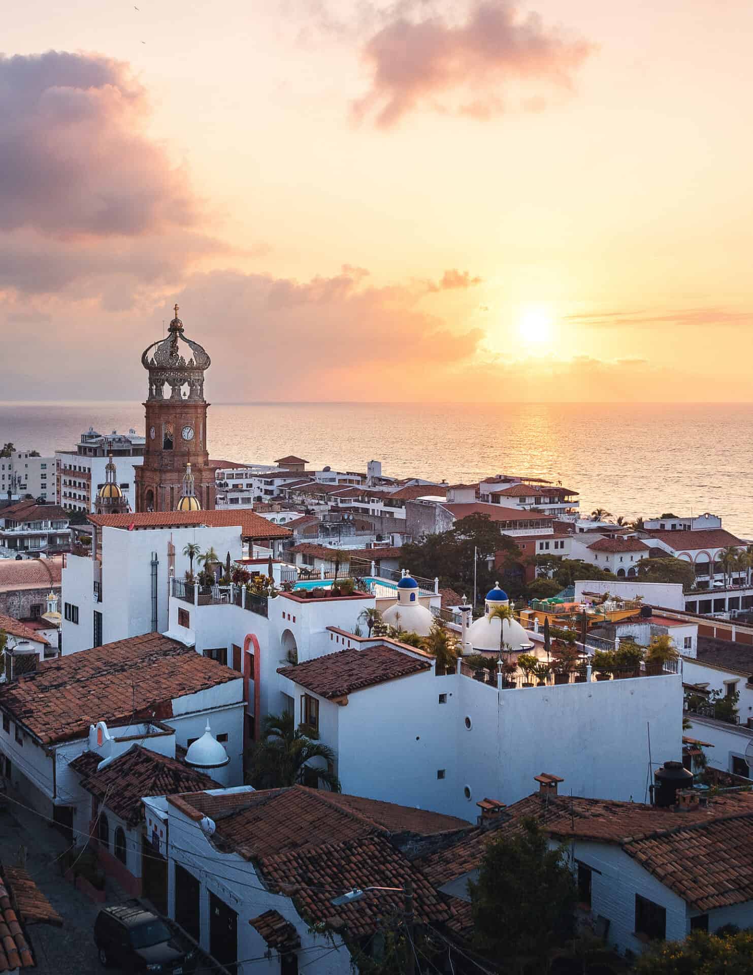 drone shot of puerto vallarta city with the ocean at sunset