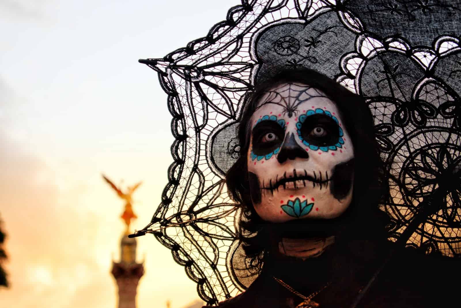 woman with calavera skull face paint and black umbrella