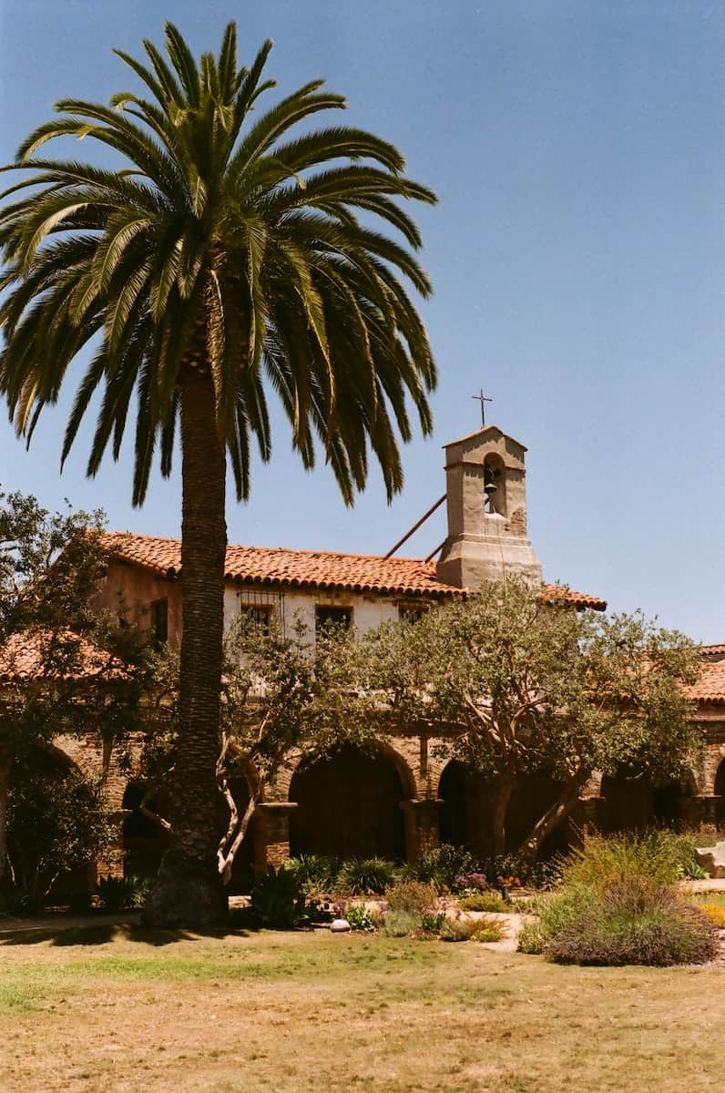 Juan capistrano stone mission building with cross on steeple