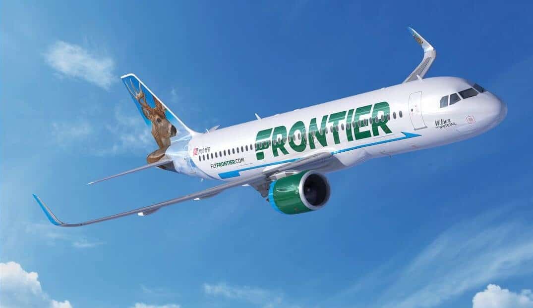 frontier airplane flying in blue sky