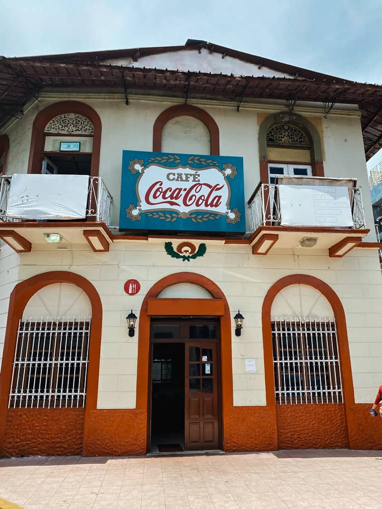 white and red Panamanian restaurant with coca cola sign