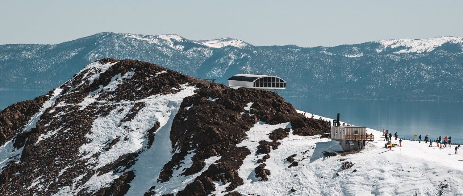 people on top of mountain skiing at lake tahoe