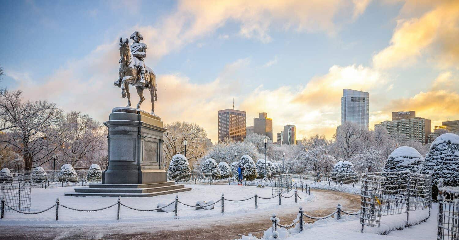 Statue on a pedestal in a snowy park