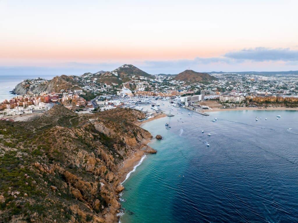 drone shot view of los cabos mountains and city on the water