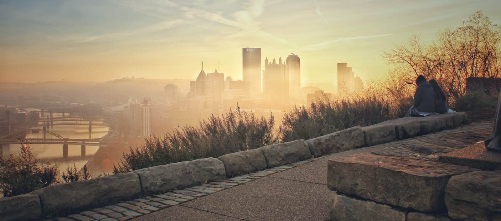 pittsburgh city buildings under morning fog during sunrise