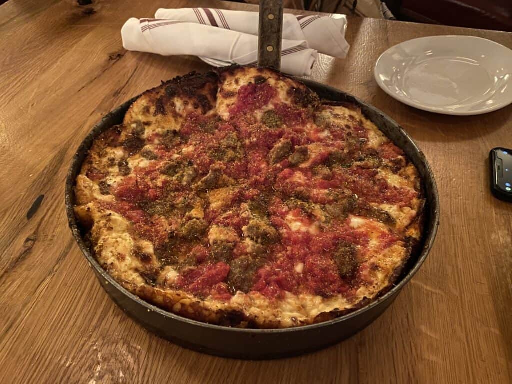 chicago style deep dish pizza with red sauce and sausage