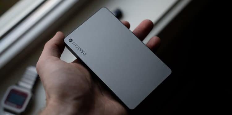 person holding silver portable charger