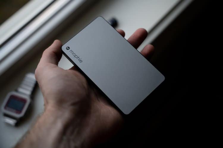 person holding silver portable charger