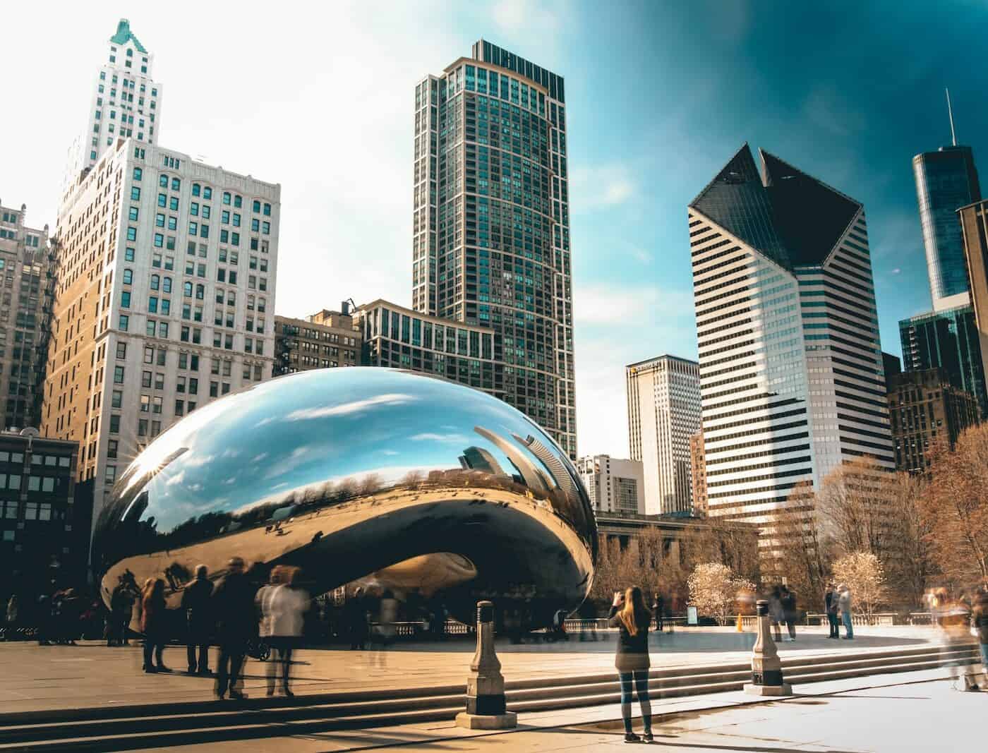 warm photo of the bean in chicago with city skyline and soft lighting